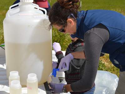 Missy Partyka, WIFSS, collects water samples