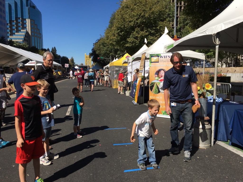 Boy at Farm-to-Fork Festival tosses bean bag