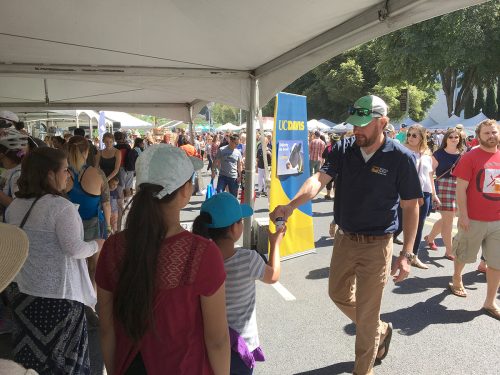 Girl receives suishy cow at Farm-to-Fork