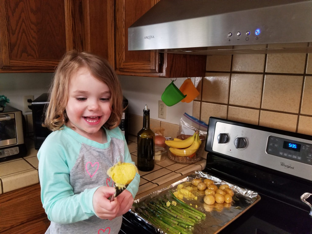 Amelia, daughter of Victor and Nicole Nisson of Davis, is having a great time helping prepare meals and learning important food safety steps.